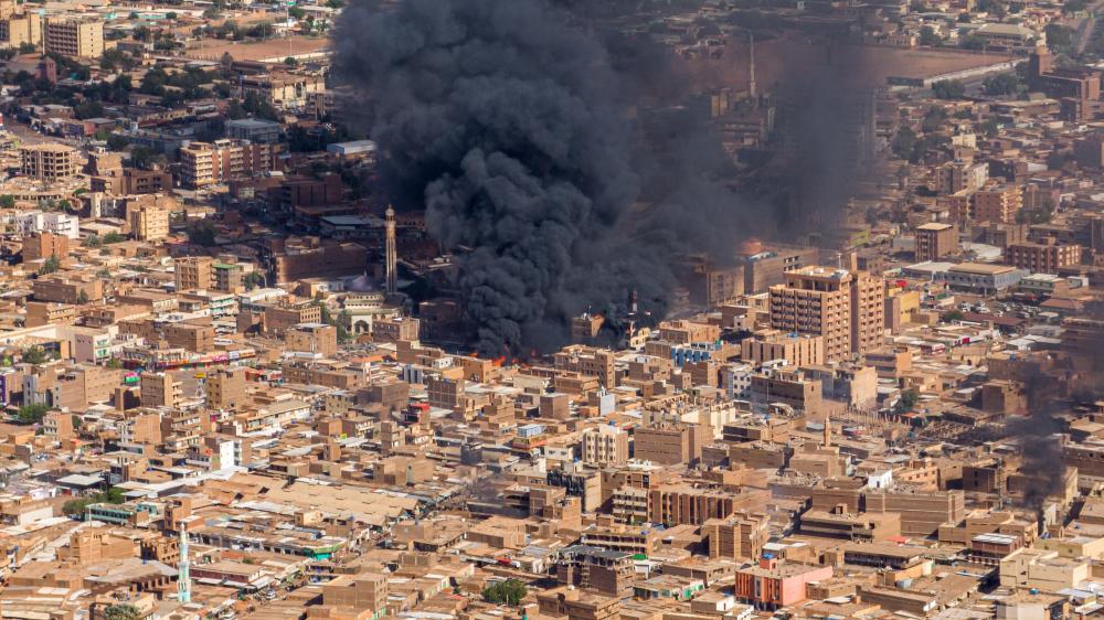 Black plume of smoke from bomb in city center of Khartoum, Sudan