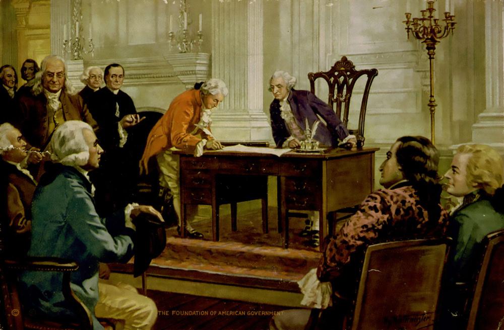 A painting of a man in a 1700s-style burnt orange coat and white wig leaning over signing a document with a quill on a wooden desk, while 10 other men, similarly dressed look on in interest. A white wall with ornate details and gold candelabaras make up the background of this painting. The signing of the United States Constitution by Gouvernor Morris, a delegate to the Constitutional Convention, presided by George Washington. Other prominent delegates are behind Morris. Painting by Henry Hintermeister.