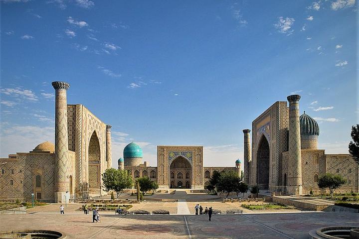 Registan Square is flanked left, right and center by three madrasahs or Islamic schools of distinctive Persian architecture. Facing are two minarets.