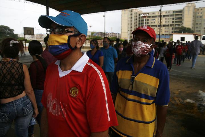 Venezuelans wait in long lines to familiarize themselves with the new voting machines to elect the new national assembly on December 6, 2020.